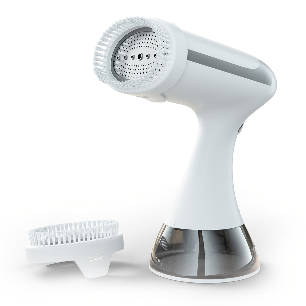 Handheld garment steamer in white with brush attachment