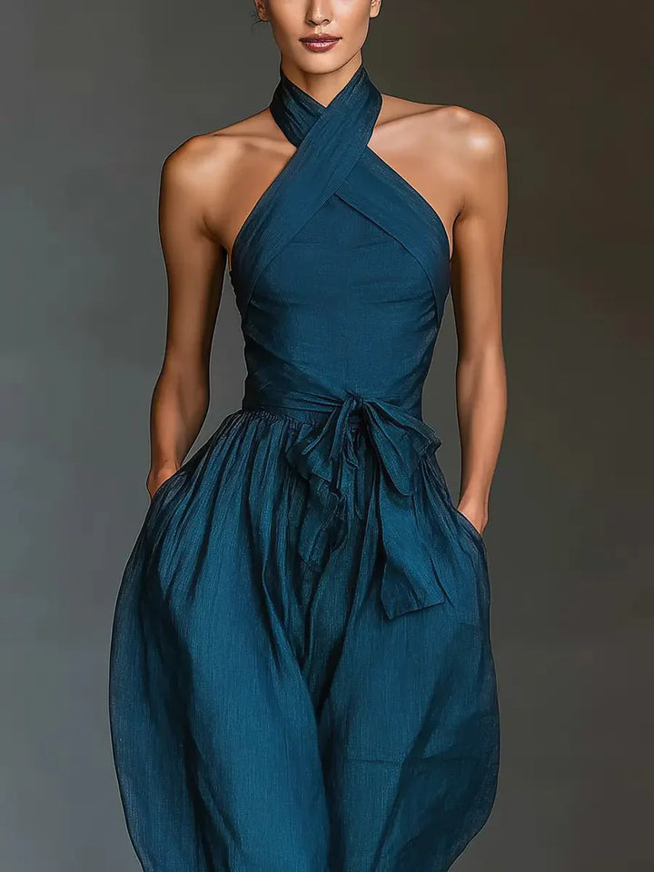 Side view of wide-leg jumpsuit highlighting flowing leg silhouette and side pocket placement on model