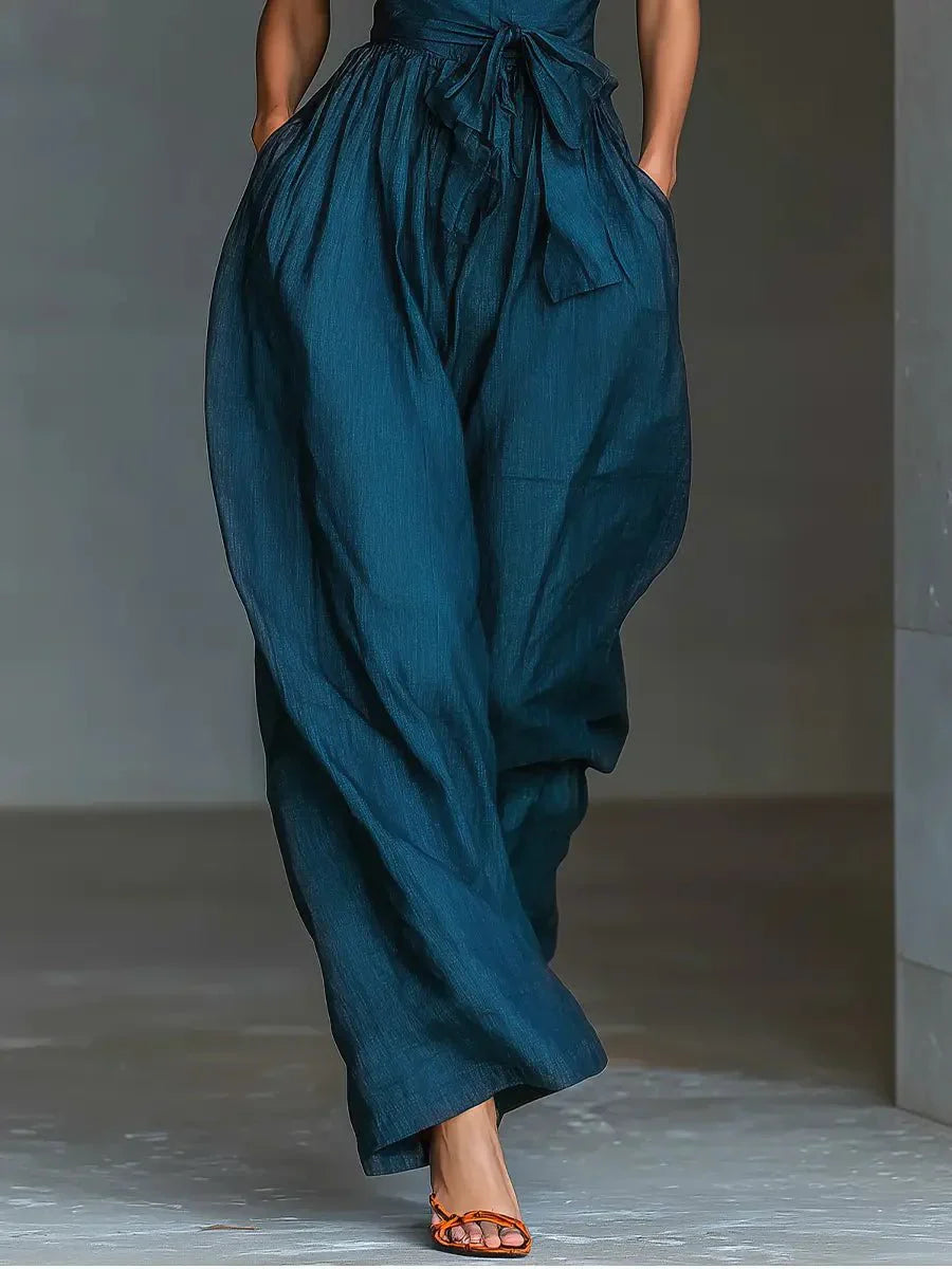 Back view of halter neck jumpsuit showing open back design and tie waist closure detail