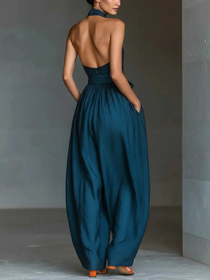 Full-length view of wide-leg jumpsuit in deep teal showcasing overall silhouette and drape on model
