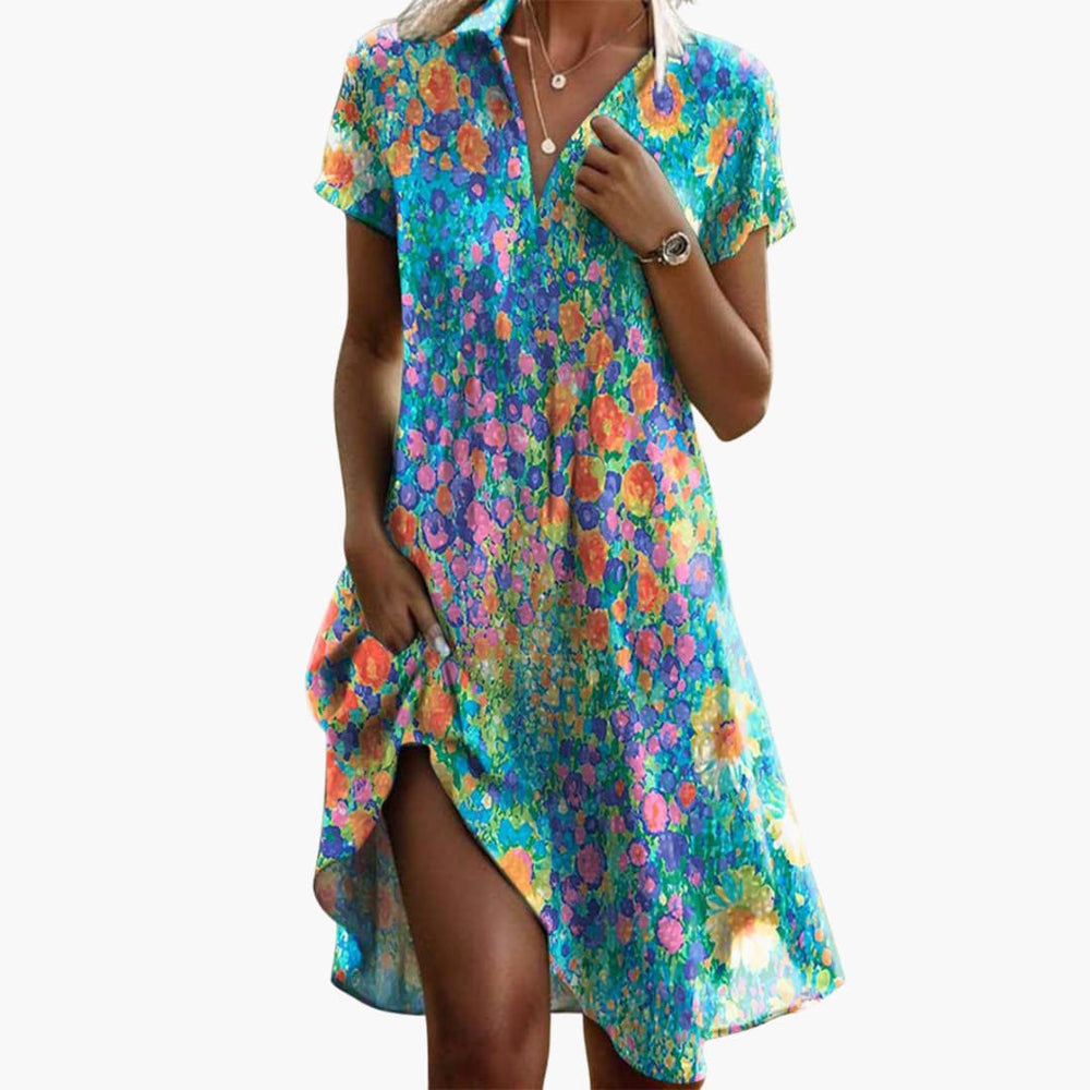 Close-up view of polka dot midi dress showing collared V-neck detail and spotted print pattern