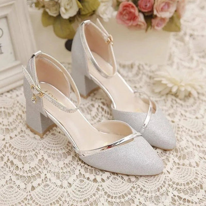 Side view of women's block heel shoes showing adjustable ankle strap and structured heel construction