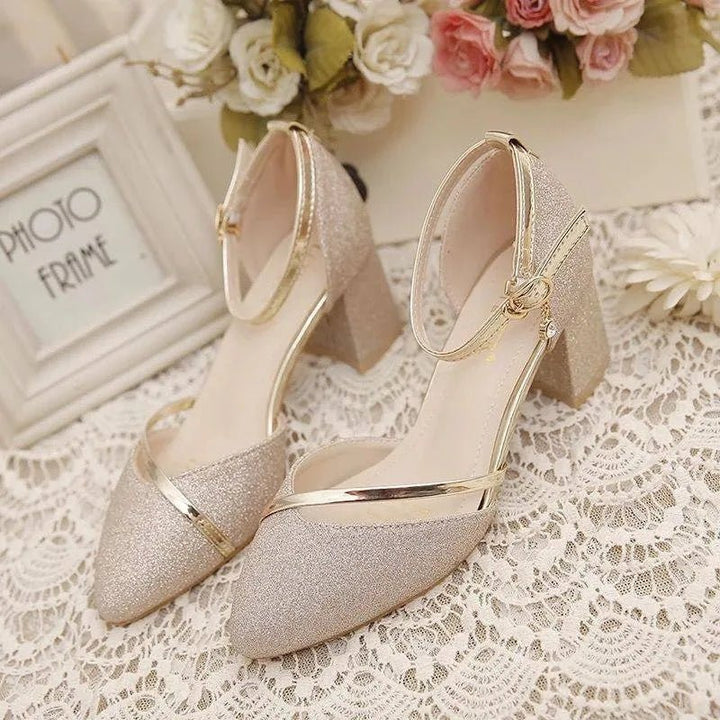 Pair of women's ankle strap block heel shoes displaying cushioned footbed and secure buckle fastening