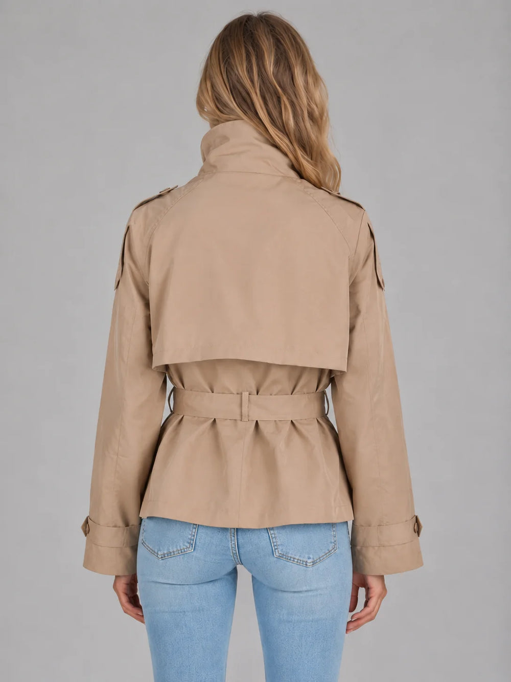 Front view of cropped trench jacket showing double-breasted button fastening and self-tie belt detail