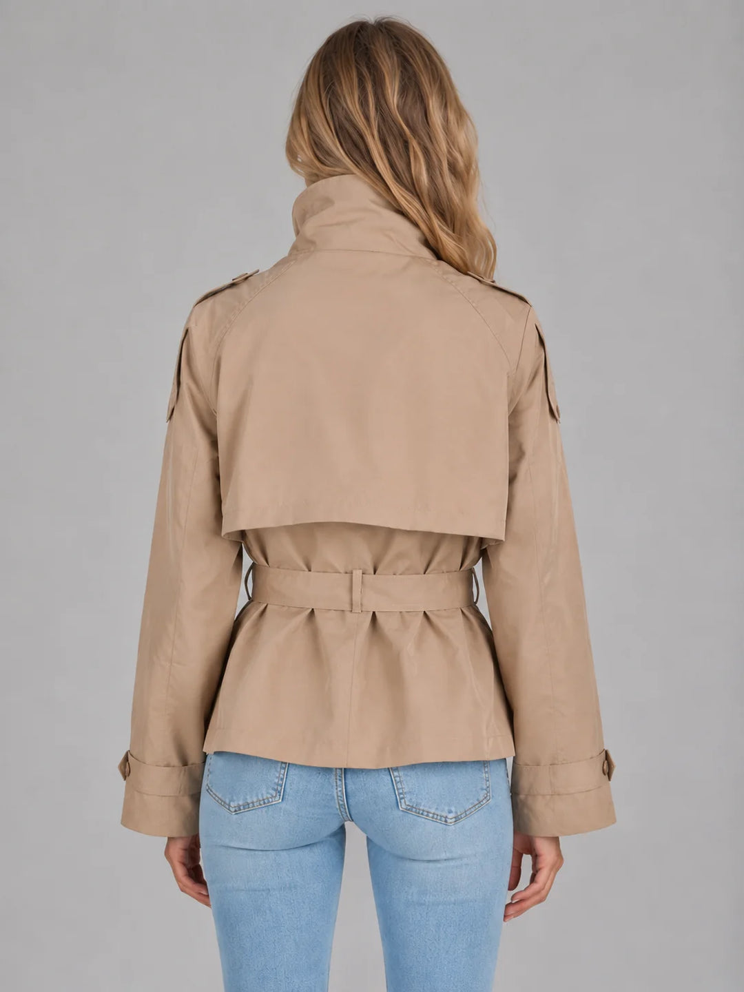 Front view of cropped trench jacket showing double-breasted button fastening and self-tie belt detail