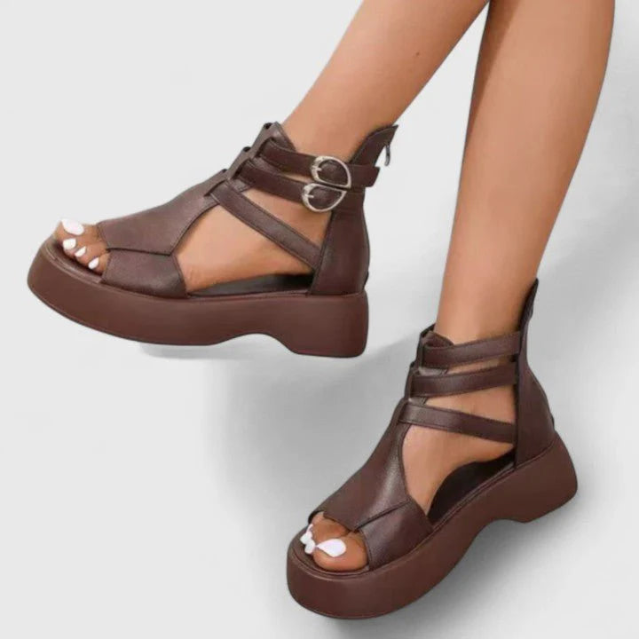 Women's gladiator platform sandals in brown with double-buckle ankle straps and chunky sole on model