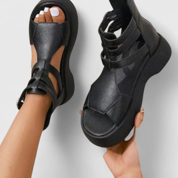 Women's gladiator platform sandals styled on model showing open-toe design and wide footbed