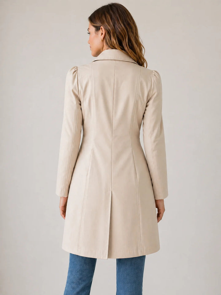Women's long trench coat styled with jeans for casual everyday wear