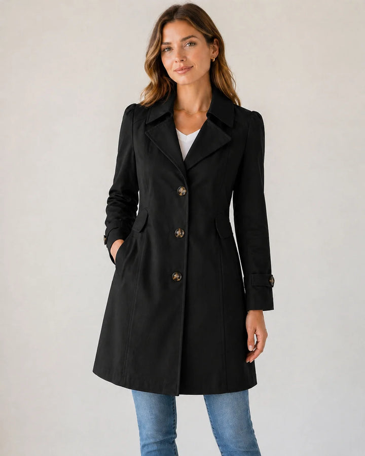 Full-length view of women's button-up trench coat in beige tone