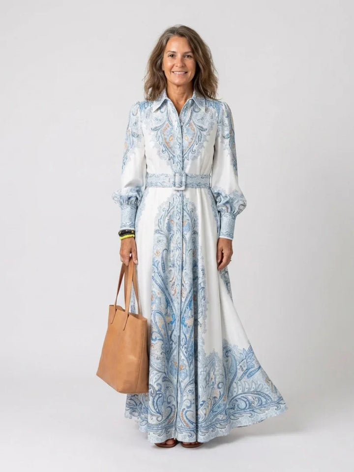 Detail of paisley print long sleeve dress with collared neckline and button-through front closure