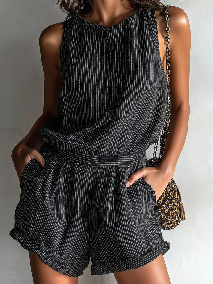 Ribbed sleeveless romper styled with accessories showing versatility for warm-weather occasions