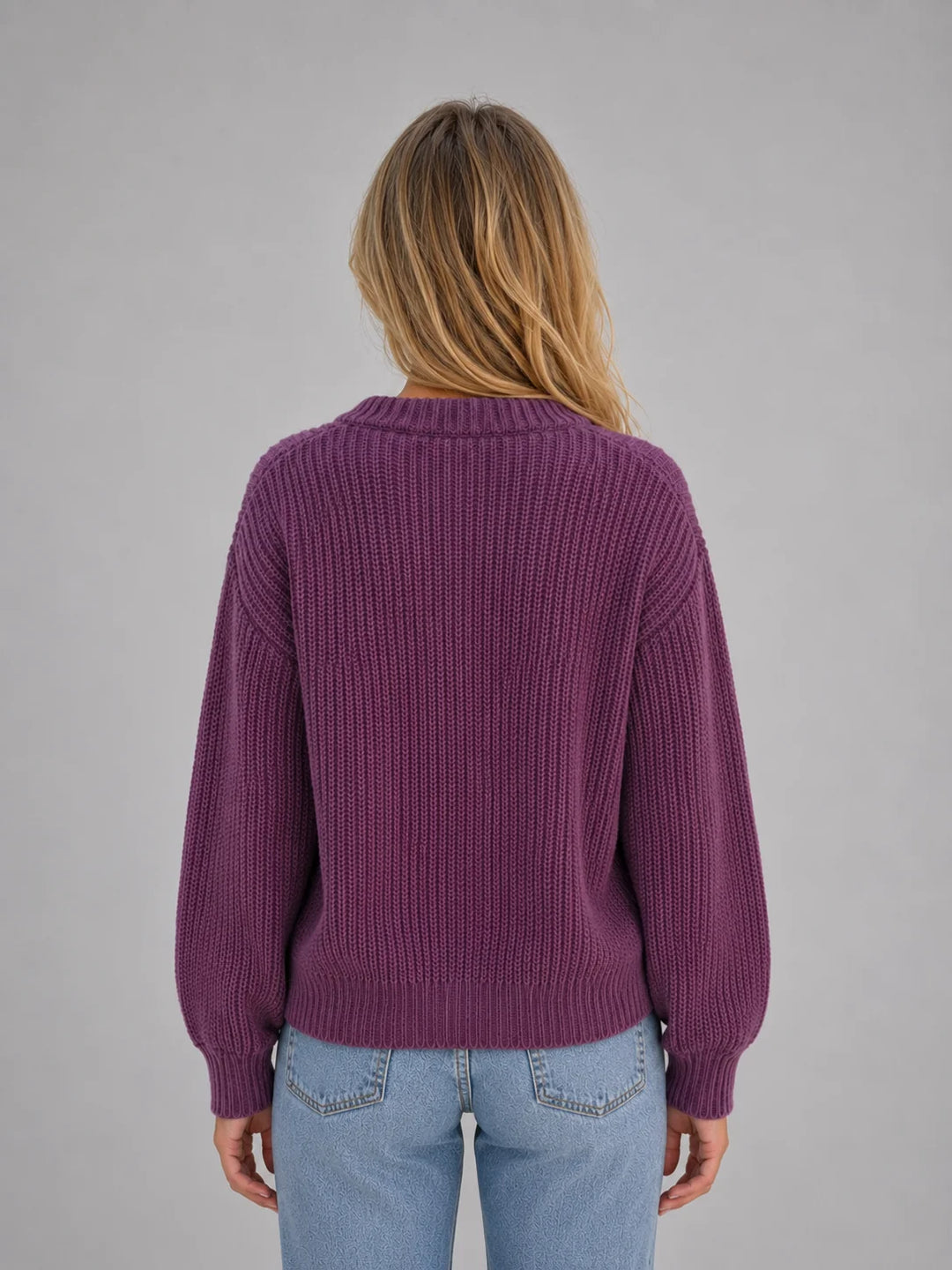 Close-up of button-front detail on women's soft ribbed jumper cardigan with textured knit