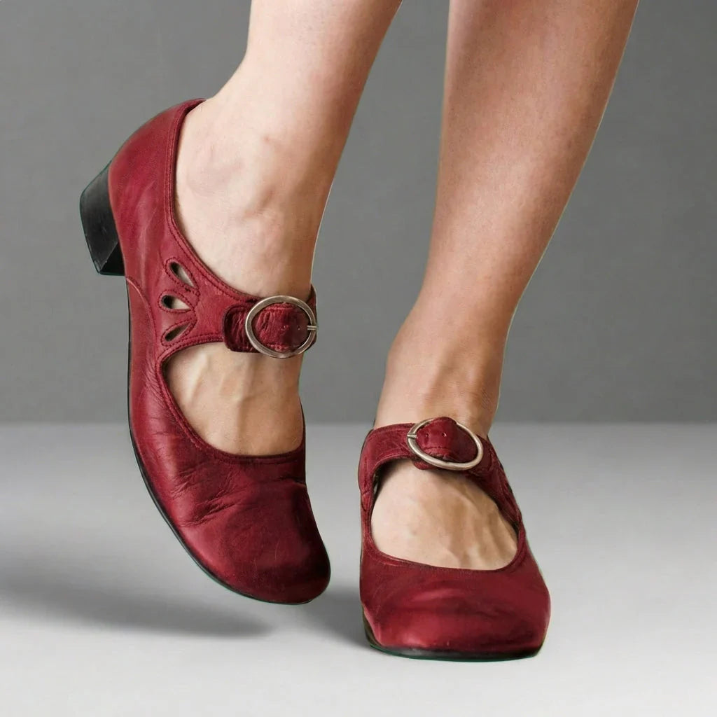 Adjustable instep strap detail on Mary Jane shoe with decorative cutout design