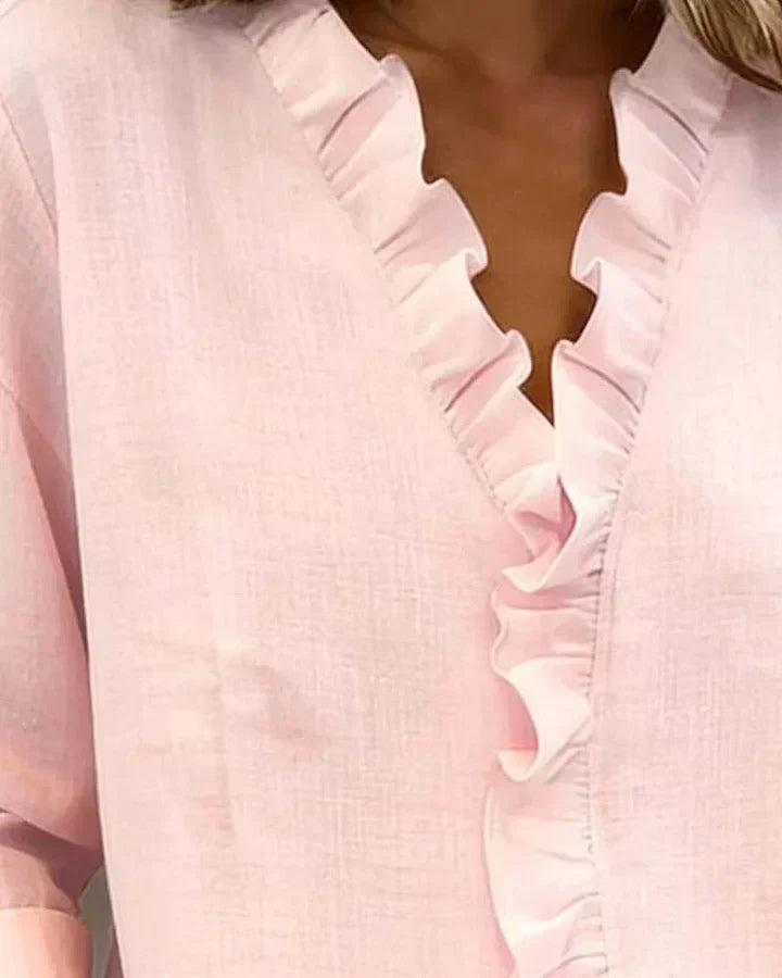 Full-length view of women's ruffle neck blouse in pink showing overall fit and style