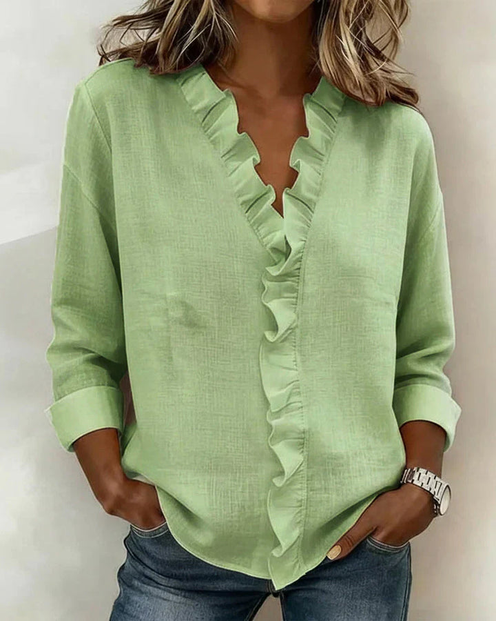 Side view of women's ruffle neck blouse showing relaxed fit and drape