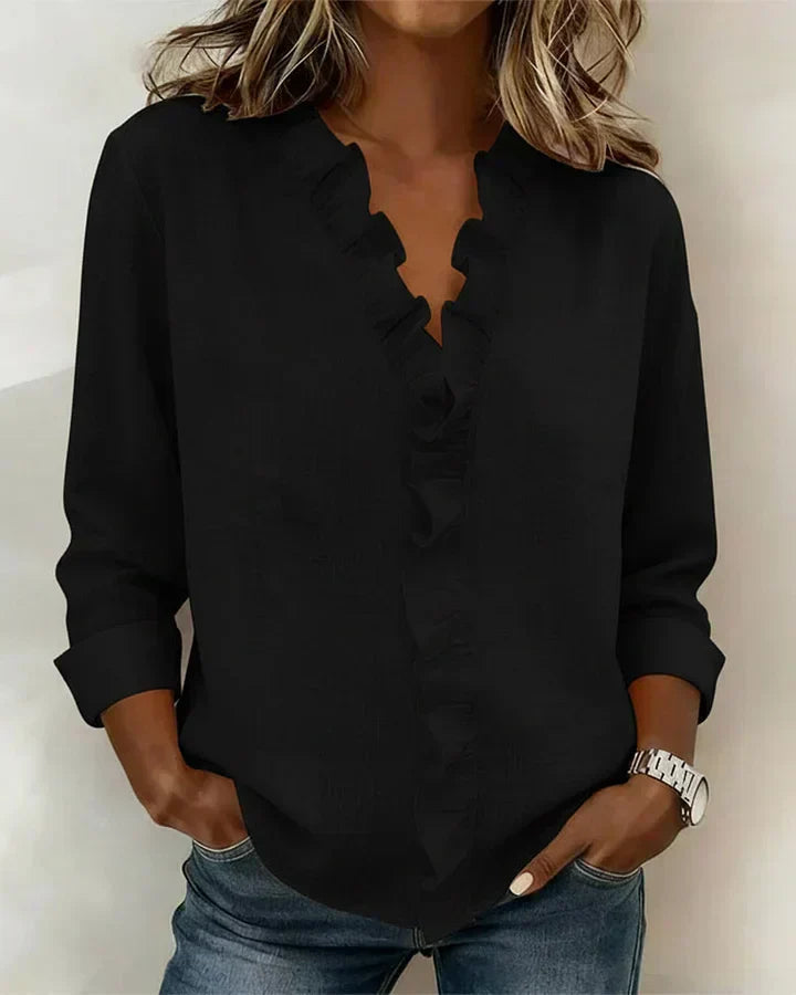 Back view of women's ruffle neck blouse displaying clean hemline and relaxed silhouette