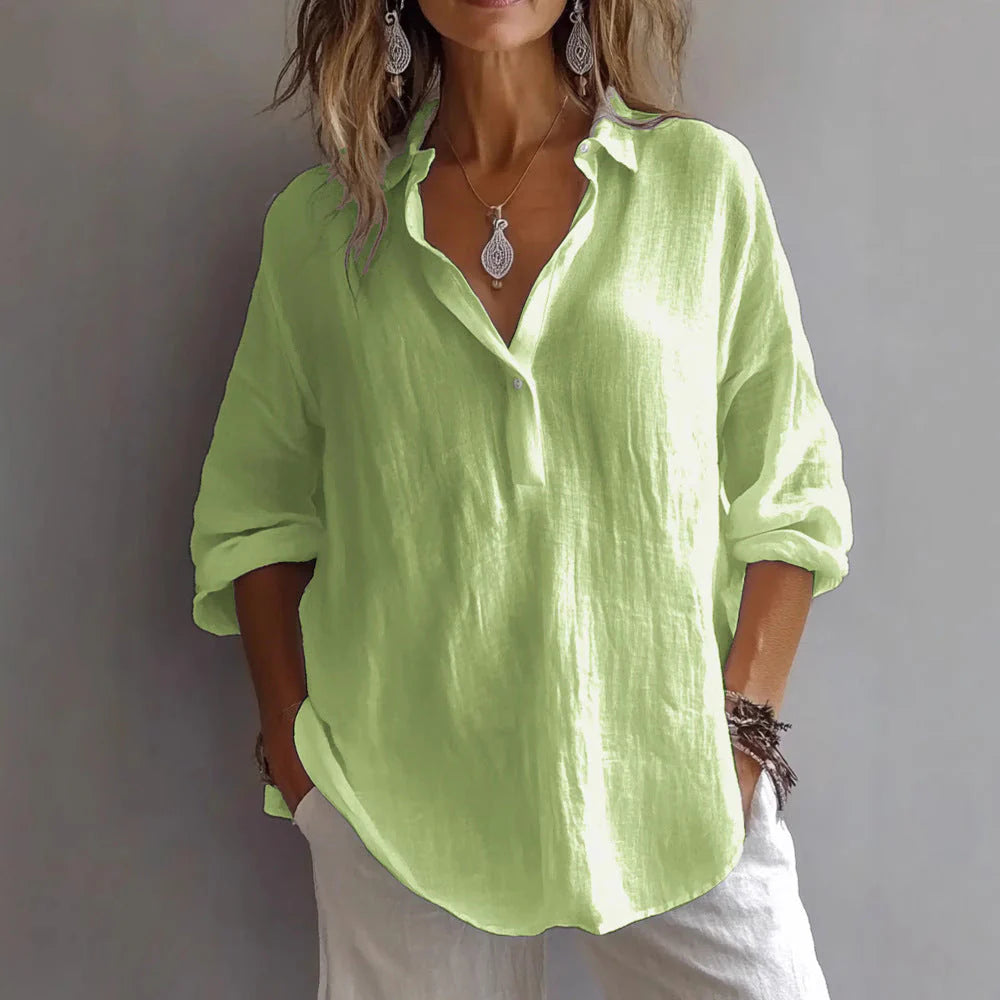 Woman in white linen shirt with rolled cuffs, showing relaxed drape and lightweight woven fabric construction