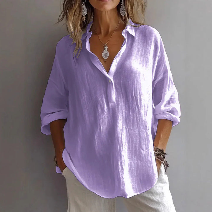 Close-up of linen shirt sleeve detail with rolled cuffs and lightweight woven construction