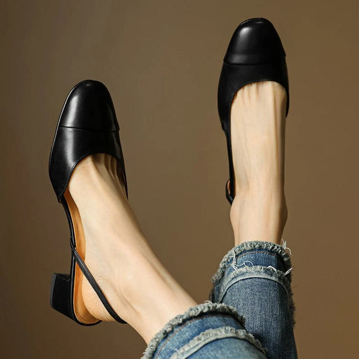Close-up of women's block heel pumps showing slip-resistant rubber outsole and heel construction