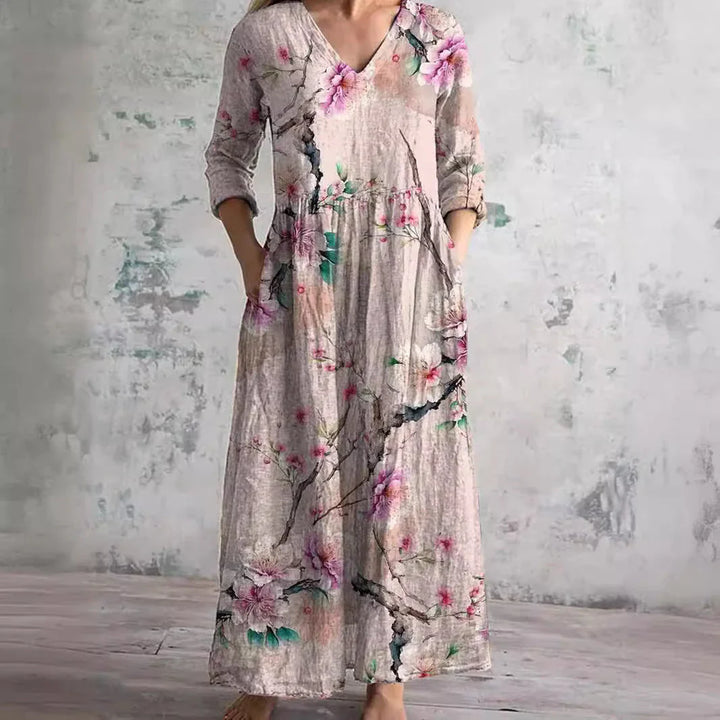 Close-up of floral print maxi dress showing rose and foliage pattern detail on woven fabric