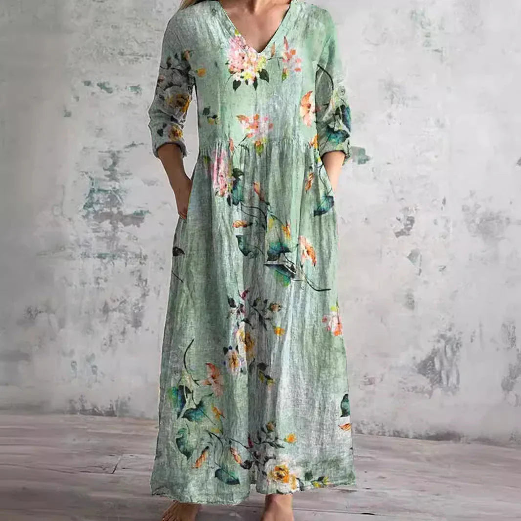 Side view of relaxed fit floral print maxi dress with gathered waist and ankle-length hem
