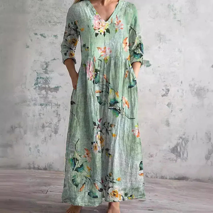 Side view of relaxed fit floral print maxi dress with gathered waist and ankle-length hem