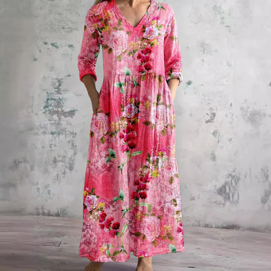 Three-quarter sleeve detail on floral print maxi dress with roll-tab cuff and V-neckline