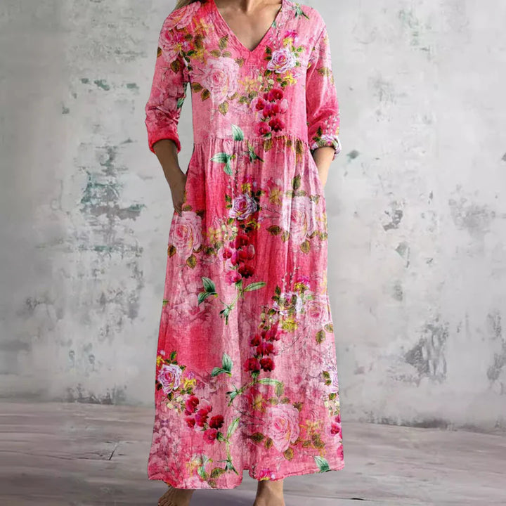 Three-quarter sleeve detail on floral print maxi dress with roll-tab cuff and V-neckline