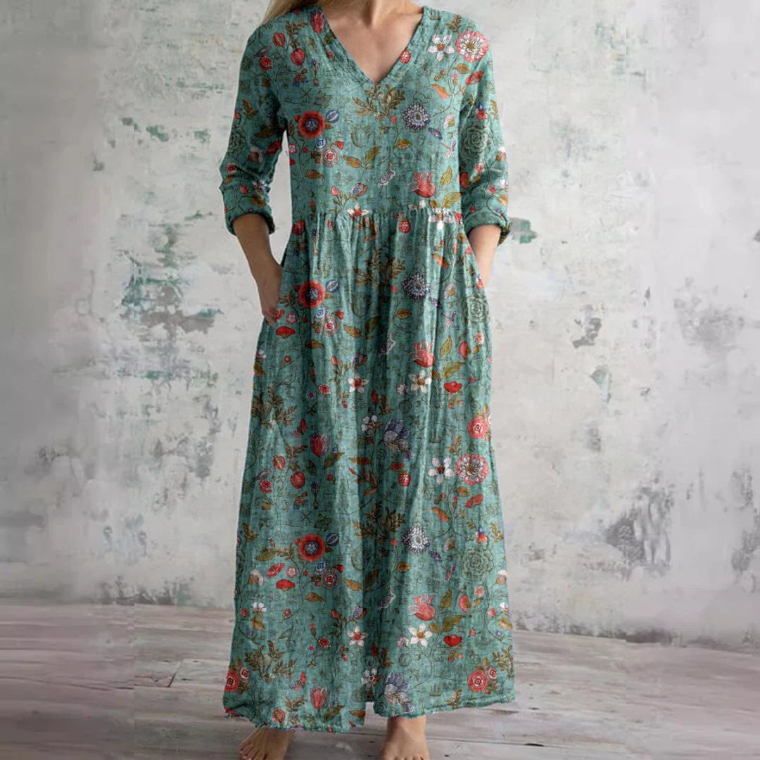 Detail of V-neckline and gathered waist on floral print maxi dress with rose pattern