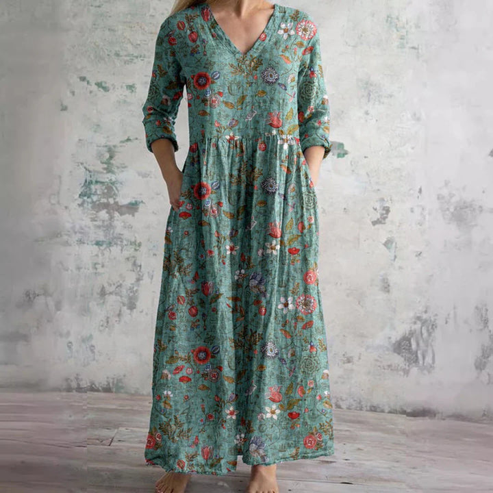 Detail of V-neckline and gathered waist on floral print maxi dress with rose pattern