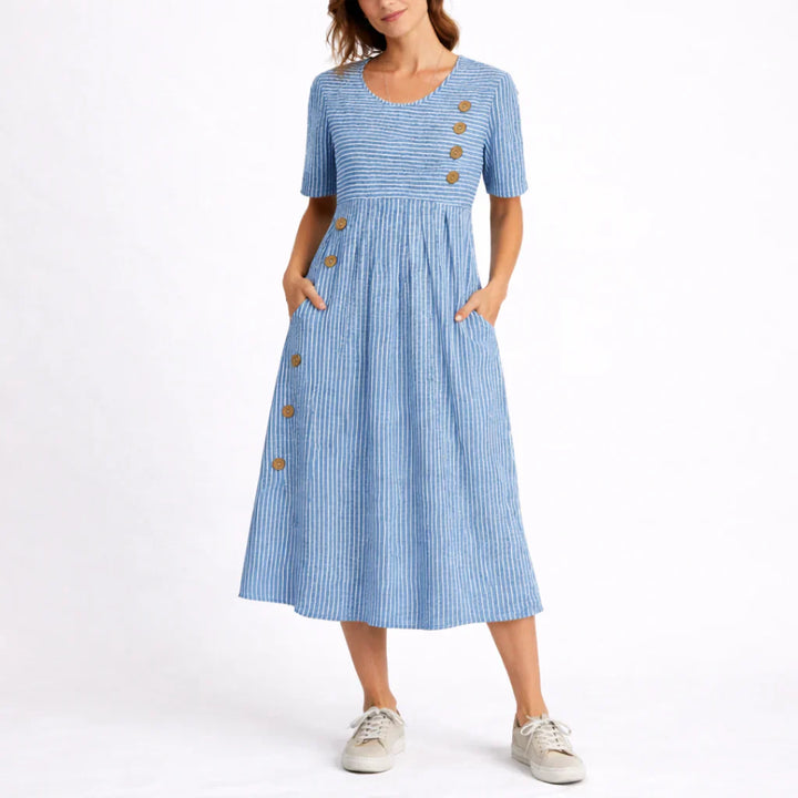 Woman wearing blue and white striped midi dress with button detail and short sleeves