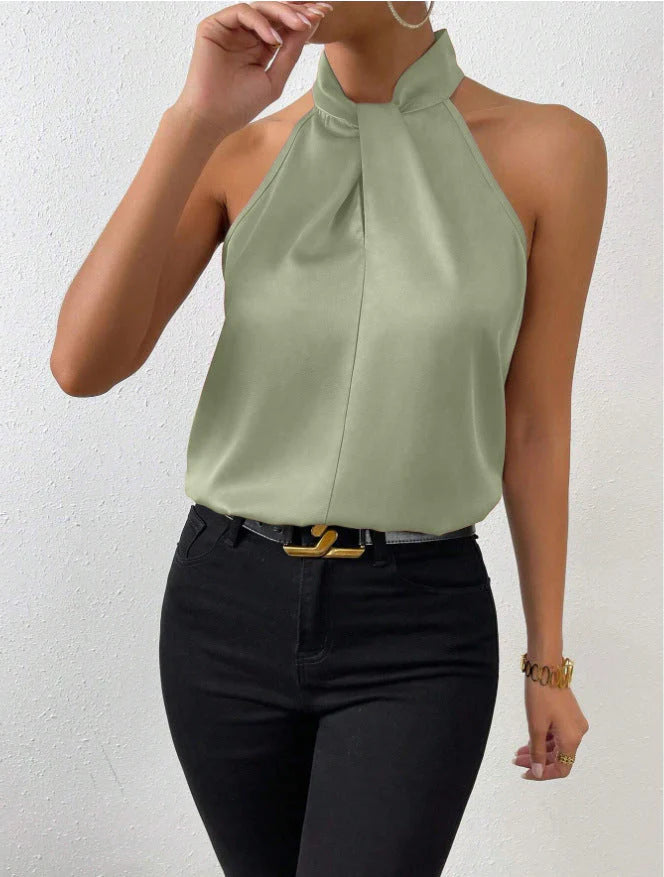 Close-up of halter neck fastening and twisted detail on champagne satin blouse