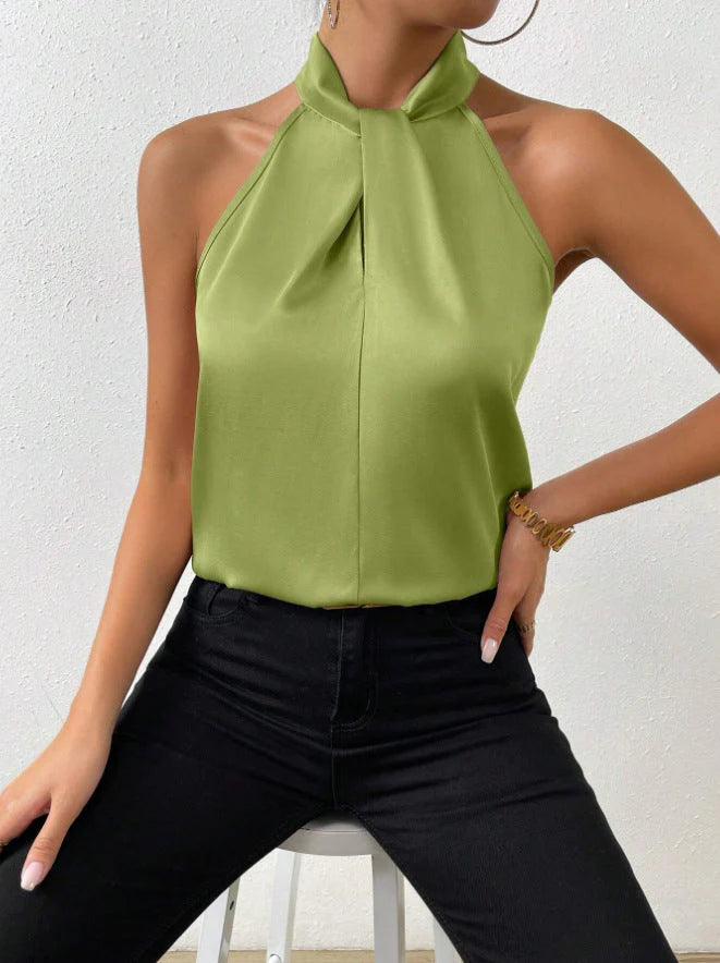 Women's sleeveless satin top showing fluid drape and lustrous fabric finish in natural light