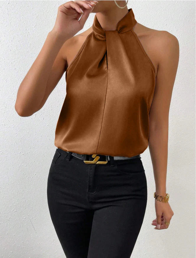 Styled look featuring champagne halter blouse with tailored black trousers and belt