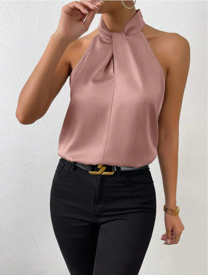 Detail of twisted halter neckline on satin blouse showing elegant draping and construction