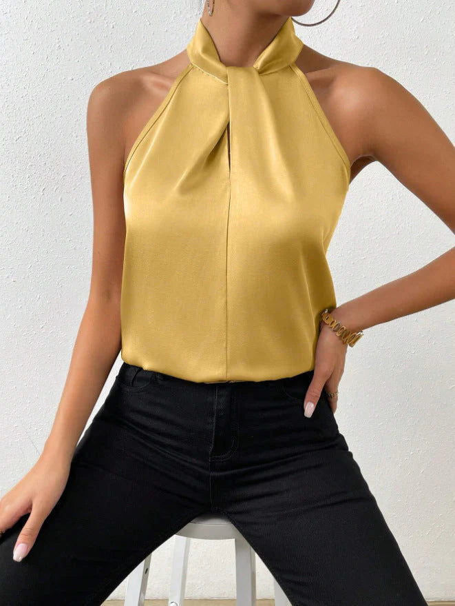 Women's halter neck top in neutral tone showing smooth fabric finish and elegant neckline