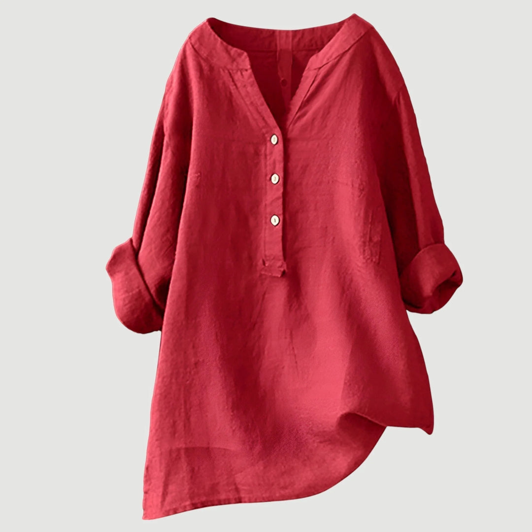 Women's relaxed v-neck linen shirt in coral with three-button placket and roll-tab sleeves on neutral background