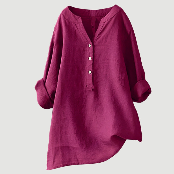 Women's coral linen shirt styled with roll-tab sleeves and soft collar