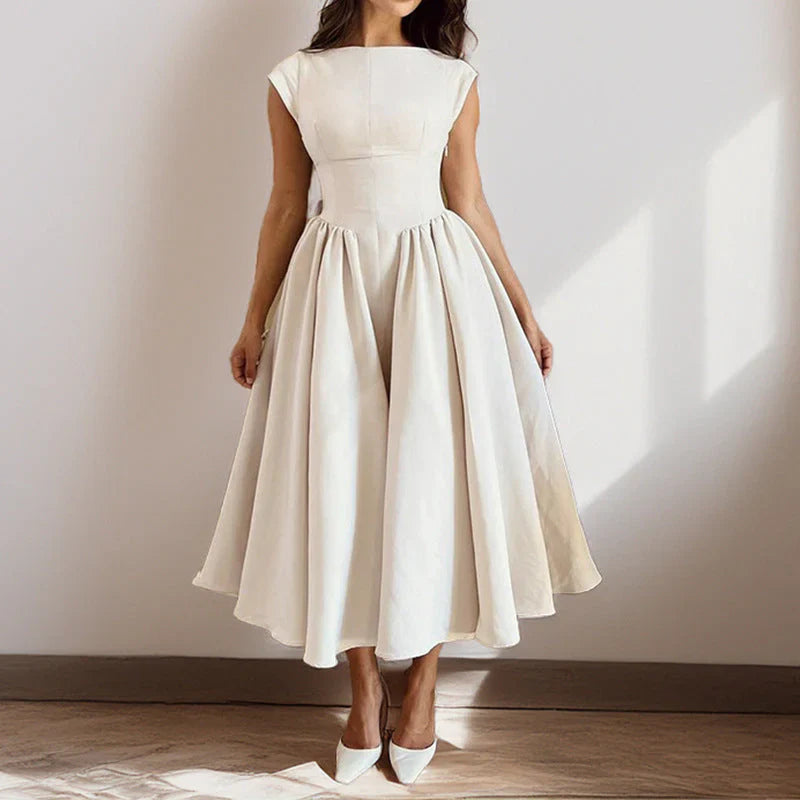 Side angle of cap sleeve midi dress with flared skirt falling below the knee