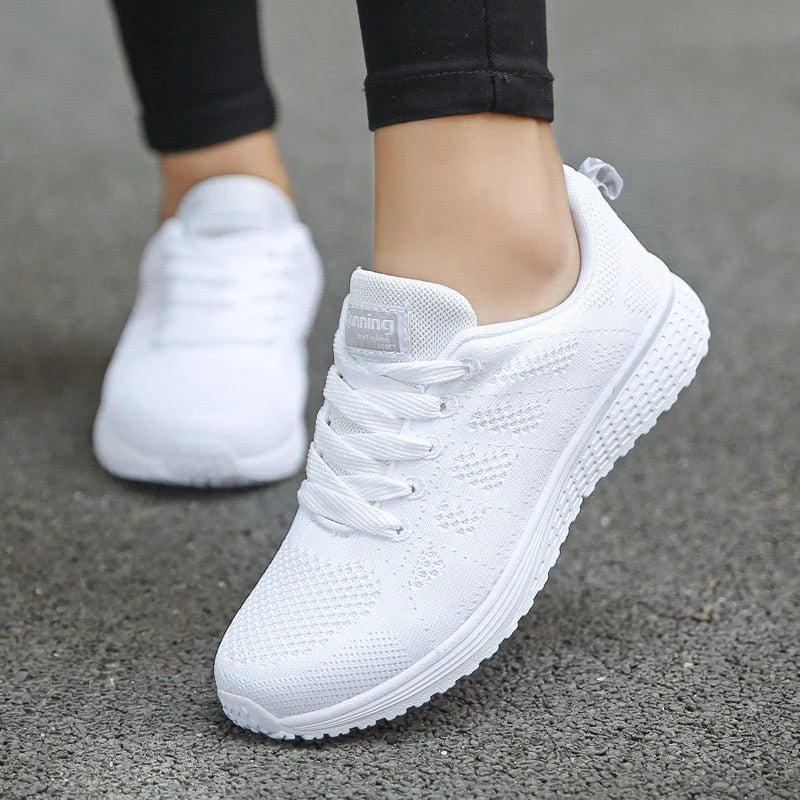 Women's lace-up mesh trainers in white with textured sole and wide toe box design