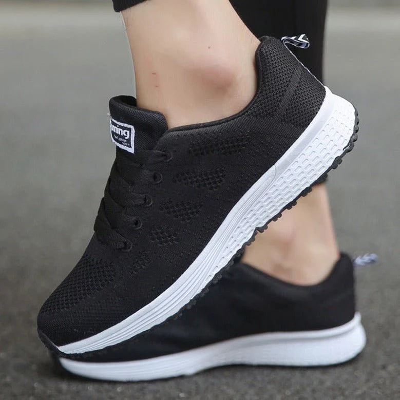 Women's mesh trainers in white styled with black skinny jeans for casual wear