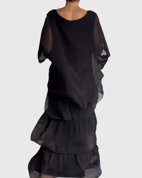 Front view of boho layered maxi dress featuring relaxed dolman sleeves and flowing three-tier skirt