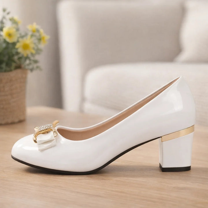 Detail shot of metallic trim on block heel of Bow Detail Block Heel Pumps