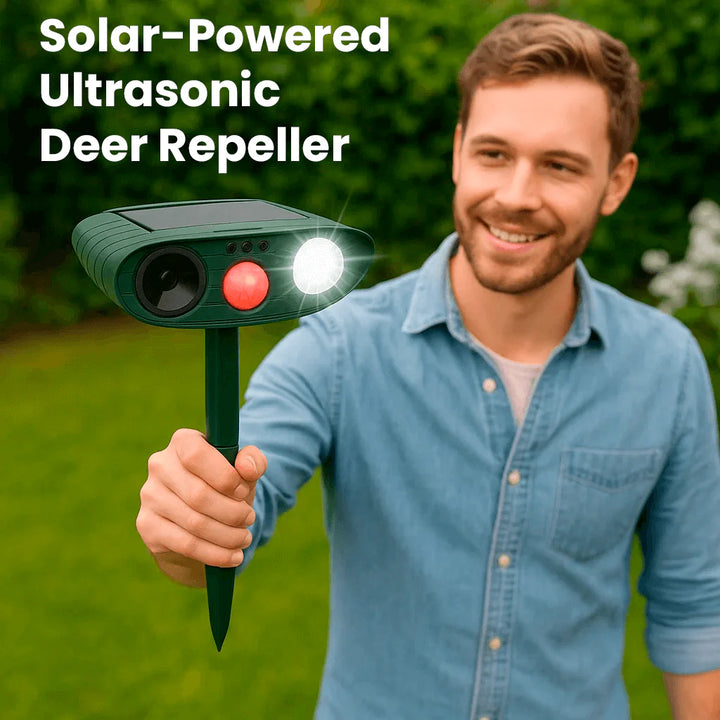 Outdoor animal deterrent with green housing, solar panel, and ground mounting stake