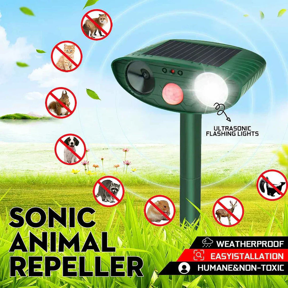 Close-up view of ultrasonic deer repeller showing solar panel and control buttons on green housing