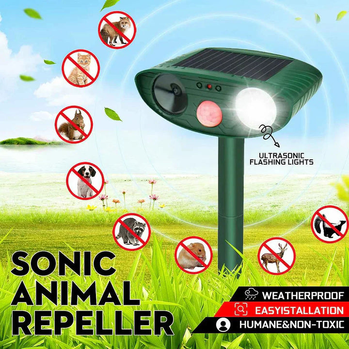 Close-up view of ultrasonic deer repeller showing solar panel and control buttons on green housing