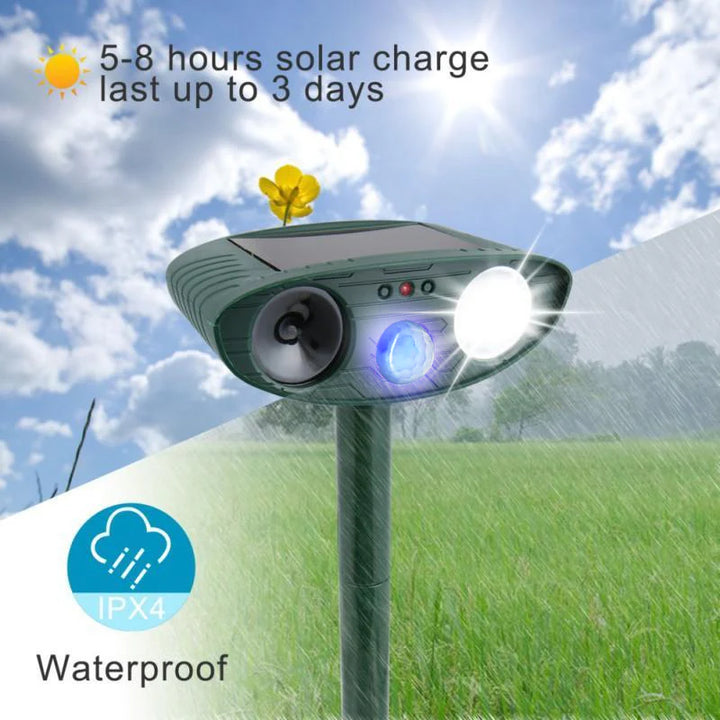 Solar-powered deer repeller with weather-resistant green casing and ground stake for outdoor installation