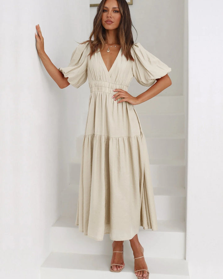 Side view showing flowing midi length skirt and wrap-style V-neckline