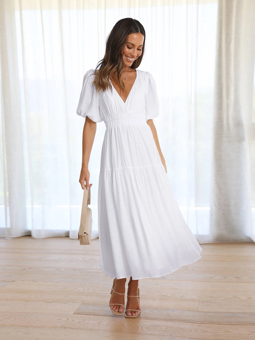 Back view of midi dress with puff sleeves and fitted waist detail
