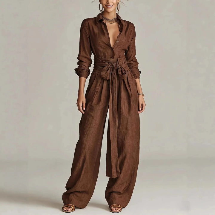 Women's belted long-sleeve jumpsuit in brown with shirt collar and wide-leg trousers worn with sandals